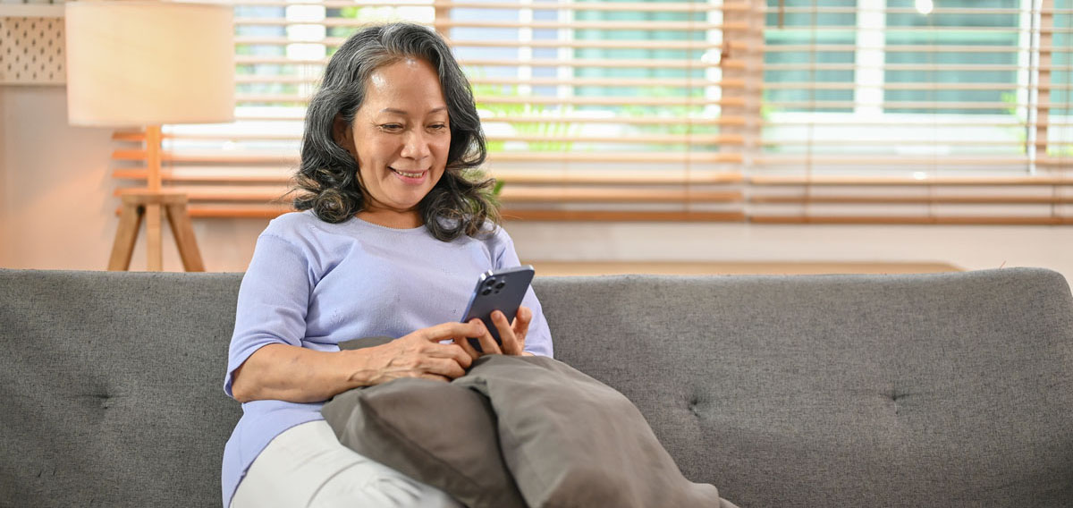 a woman sitting on a couch using her mobile phone